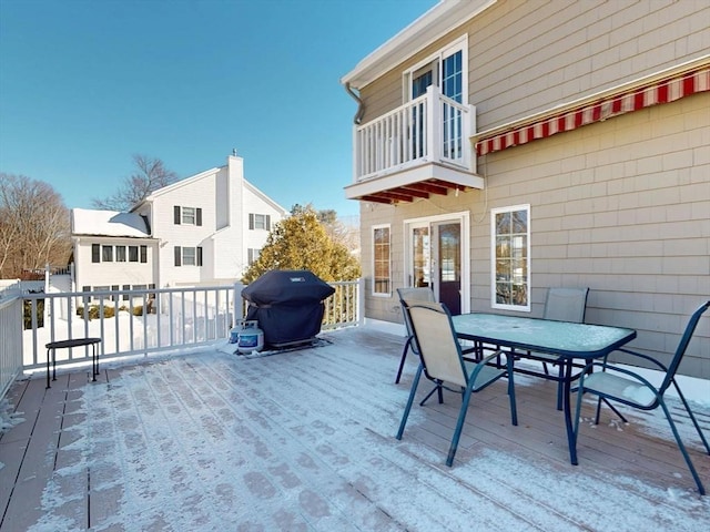 wooden terrace with grilling area and outdoor dining space