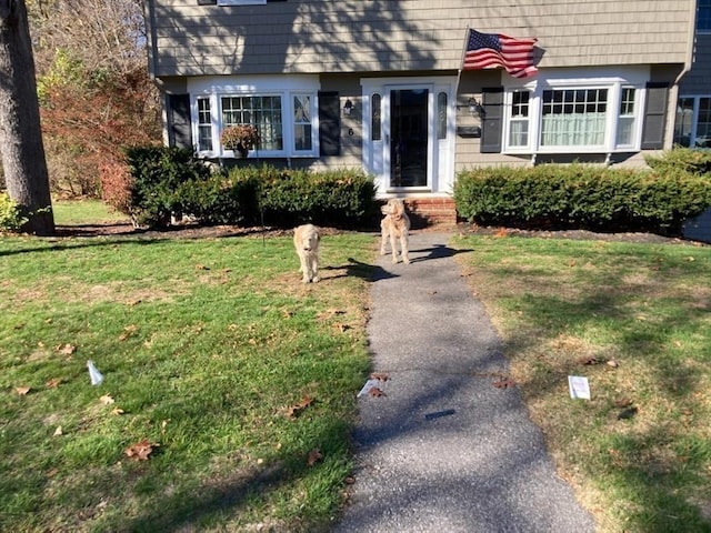 colonial-style house with a front yard