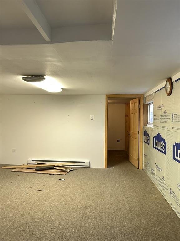 spare room featuring light carpet and a baseboard heating unit
