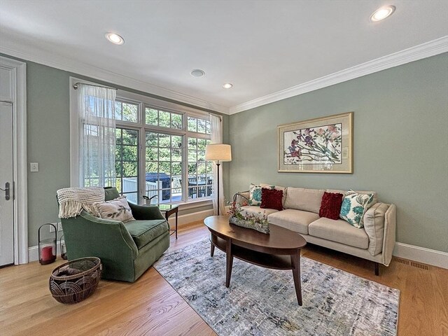 32 Twitchell St, Wellesley, MA 02482 - living room with ornamental molding, wood finished floors, recessed lighting, and baseboards