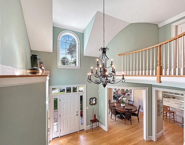 32 Twitchell St, Wellesley, MA 02482 - entrance foyer with ornamental molding, light wood finished floors, a chandelier, and baseboards