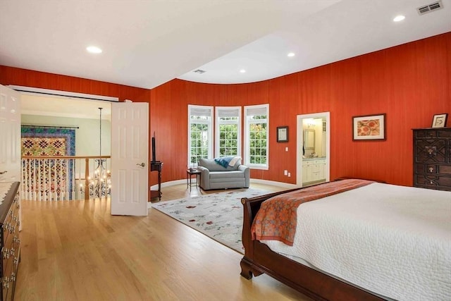 32 Twitchell St, Wellesley, MA 02482 - bedroom with a chandelier, wood finished floors, wooden walls, recessed lighting, and baseboards