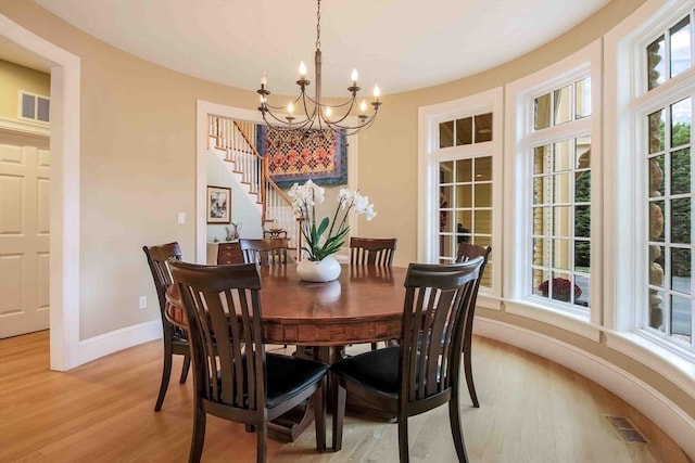 32 Twitchell St, Wellesley, MA 02482 - dining room with a chandelier, light wood finished floors, baseboards, and stairs