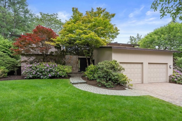 12 Laurus Ln, Newton, MA 02459 - mid-century inspired home with a garage, decorative driveway, and a front lawn