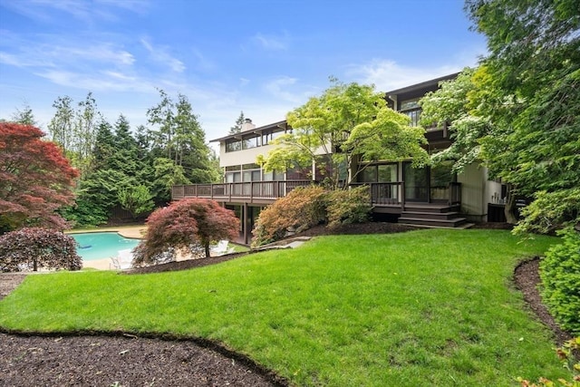 12 Laurus Ln, Newton, MA 02459 - back of property with a yard, a deck, and an outdoor pool