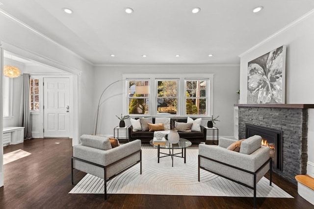 living area featuring dark wood-type flooring, recessed lighting, a fireplace, crown molding, and baseboards