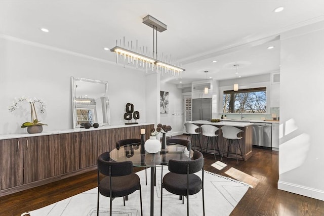 dining room with dark wood finished floors, recessed lighting, baseboards, and ornamental molding