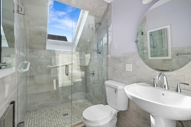 bathroom featuring sink, toilet, an enclosed shower, and tile walls