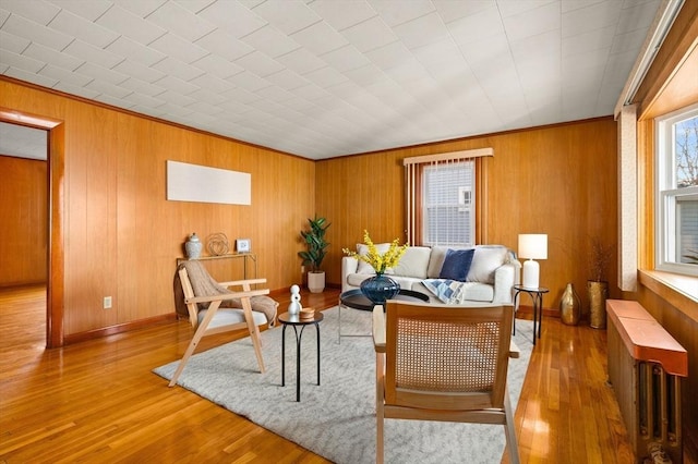 living room with radiator, hardwood / wood-style floors, and crown molding