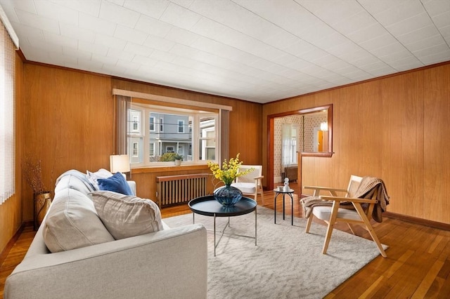 living room with hardwood / wood-style flooring and radiator