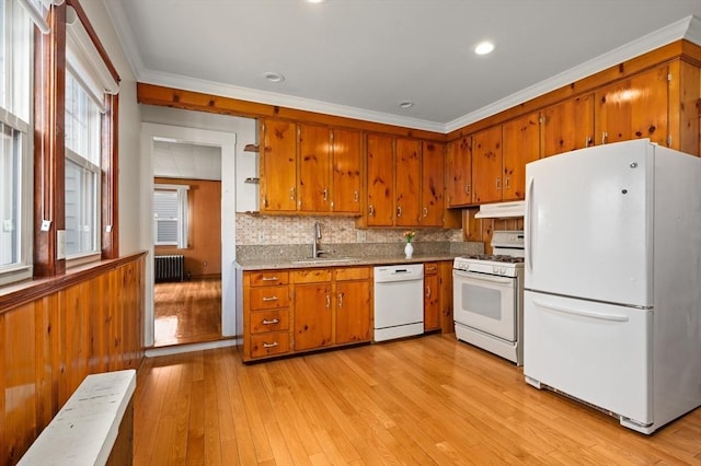 kitchen with sink, radiator heating unit, white appliances, and crown molding