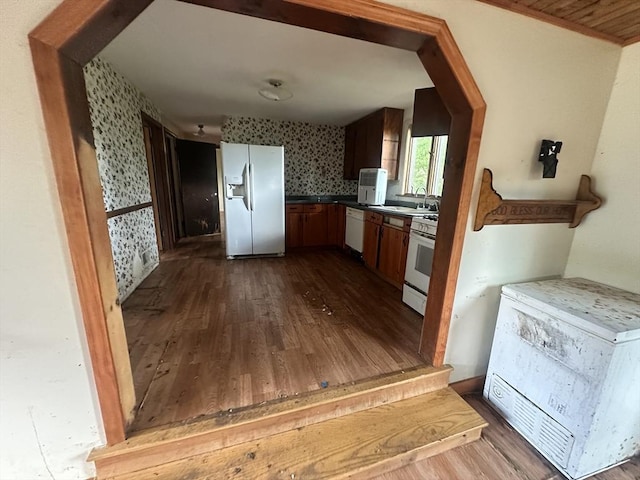 38 Conlyn Ave, Franklin, MA 02038 - kitchen with white appliances, wallpapered walls, dark wood finished floors, and dark countertops