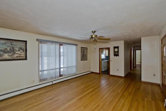 spare room with a baseboard radiator, ceiling fan, and light wood-type flooring