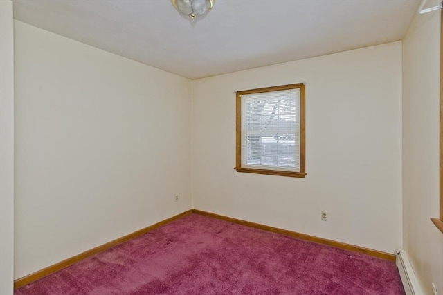 carpeted empty room with a baseboard heating unit