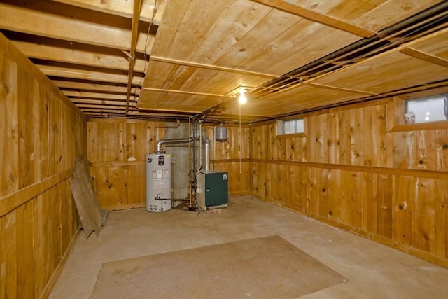 basement with water heater, wood ceiling, and wooden walls