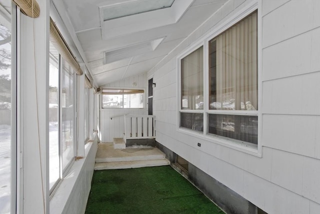 unfurnished sunroom with vaulted ceiling