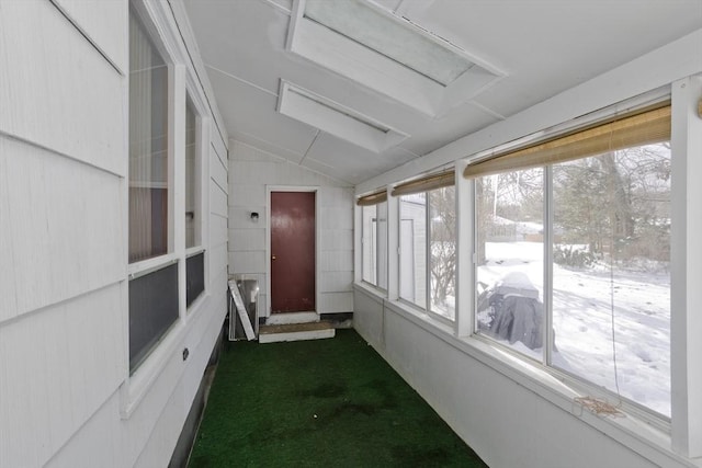 unfurnished sunroom featuring vaulted ceiling