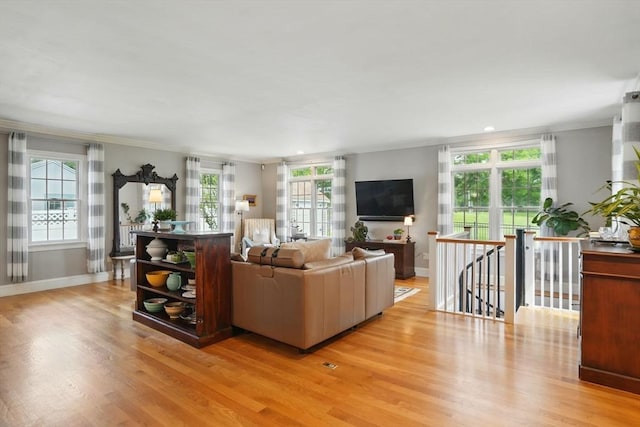149 Acorn St, Marshfield, MA 02050 - living room with crown molding, light wood-style floors, healthy amount of natural light, and baseboards