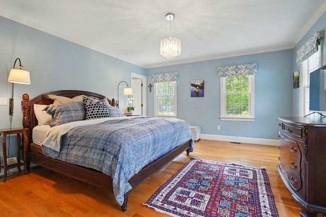 149 Acorn St, Marshfield, MA 02050 - bedroom with crown molding, wood finished floors, a chandelier, and baseboards