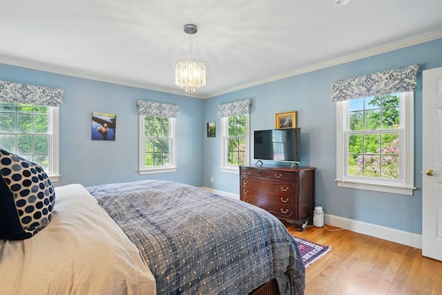 149 Acorn St, Marshfield, MA 02050 - bedroom featuring a chandelier, baseboards, light wood-type flooring, and crown molding