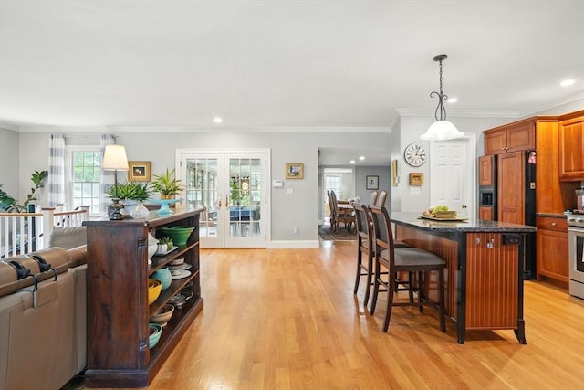 149 Acorn St, Marshfield, MA 02050 - kitchen featuring light wood-style floors, a breakfast bar area, a center island, french doors, and recessed lighting
