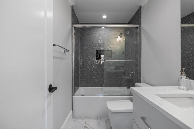 full bathroom with bath / shower combo with glass door, vanity, and toilet