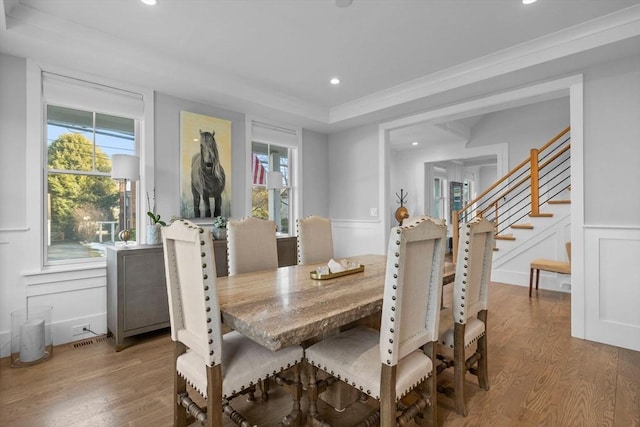 dining space with wood-type flooring