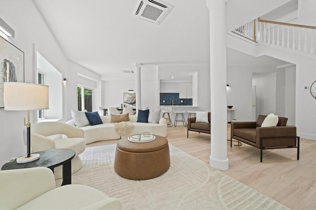 44 Ober Rd Unit 44, Newton, MA 02459 - living area with decorative columns, wood finished floors, and a towering ceiling