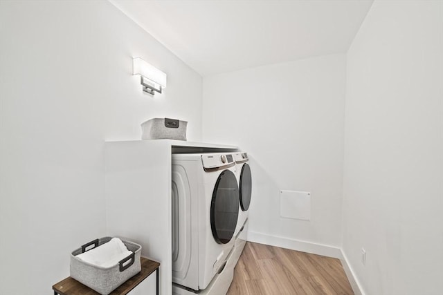 44 Ober Rd Unit 44, Newton, MA 02459 - laundry area featuring washer and clothes dryer, light wood-type flooring, and baseboards