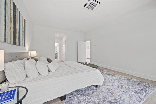 44 Ober Rd Unit 44, Newton, MA 02459 - bedroom featuring wood finished floors, baseboards, and connected bathroom