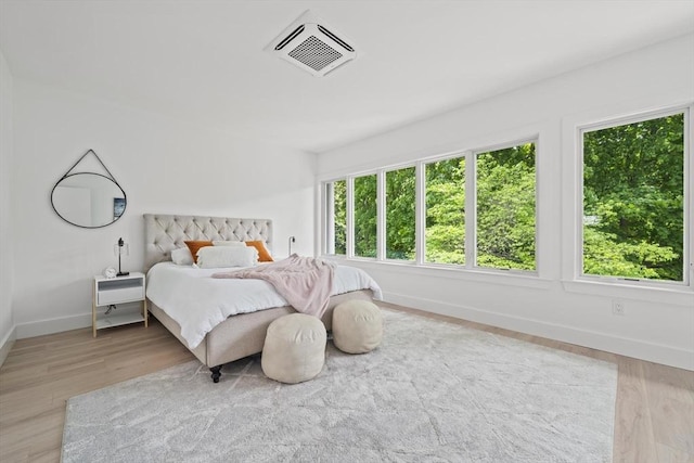 44 Ober Rd Unit 44, Newton, MA 02459 - bedroom with multiple windows, baseboards, and light wood-style floors