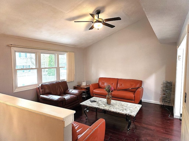 living room featuring a textured ceiling, baseboards, dark wood finished floors, ceiling fan, and vaulted ceiling