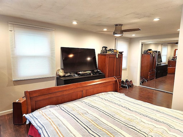 bedroom featuring a closet, recessed lighting, baseboards, ceiling fan, and wood finished floors
