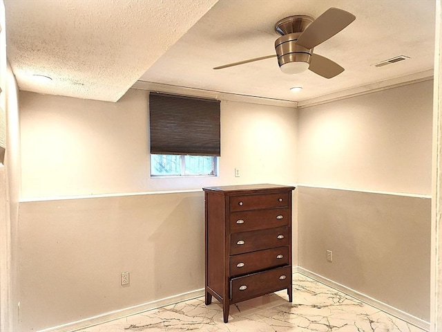 unfurnished bedroom featuring baseboards, marble finish floor, visible vents, and a textured ceiling