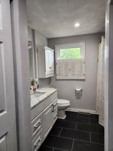 full bath with toilet, vanity, tile patterned floors, baseboards, and recessed lighting