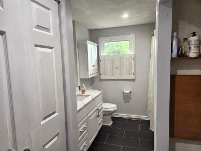 bathroom with toilet, tile patterned flooring, vanity, and baseboards