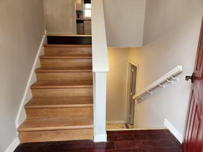 stairway with baseboards and wood finished floors