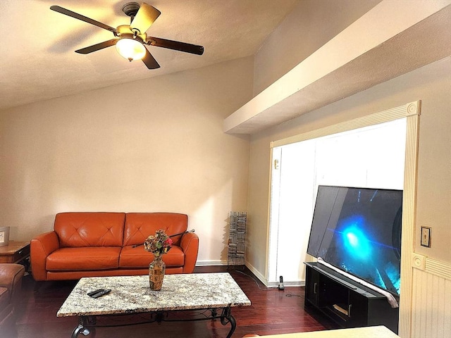 living area with dark wood-type flooring, baseboards, and ceiling fan