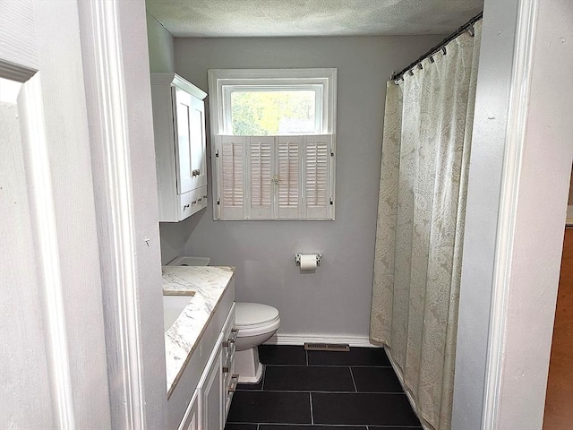 bathroom featuring toilet, baseboards, visible vents, tile patterned floors, and vanity
