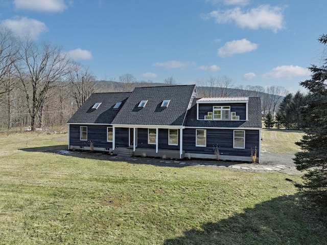 rear view of property featuring a yard and roof with shingles