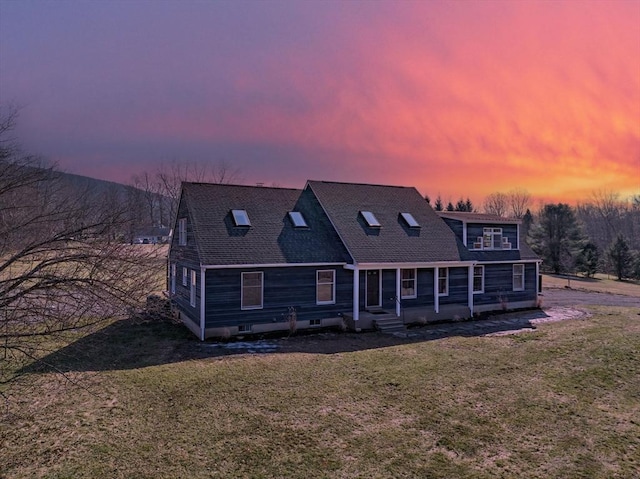 view of front of property with roof with shingles and a front yard