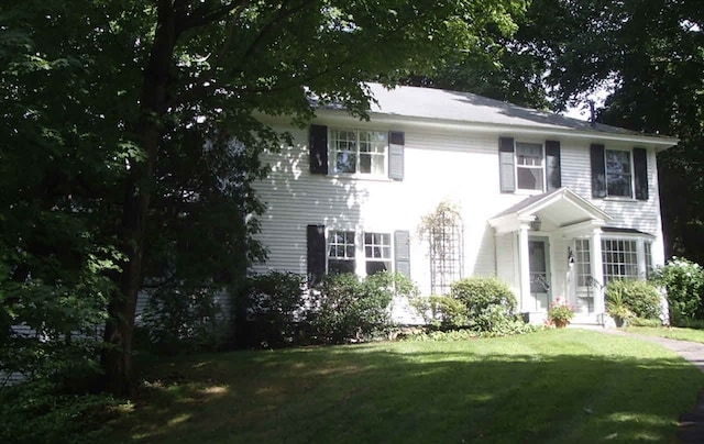 colonial inspired home with a front yard