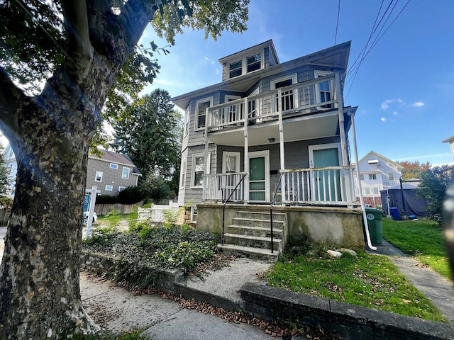 view of front of home featuring covered porch and a balcony