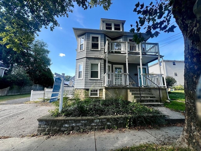 view of front facade featuring a balcony and a porch