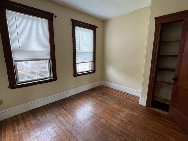 spare room with dark hardwood / wood-style flooring