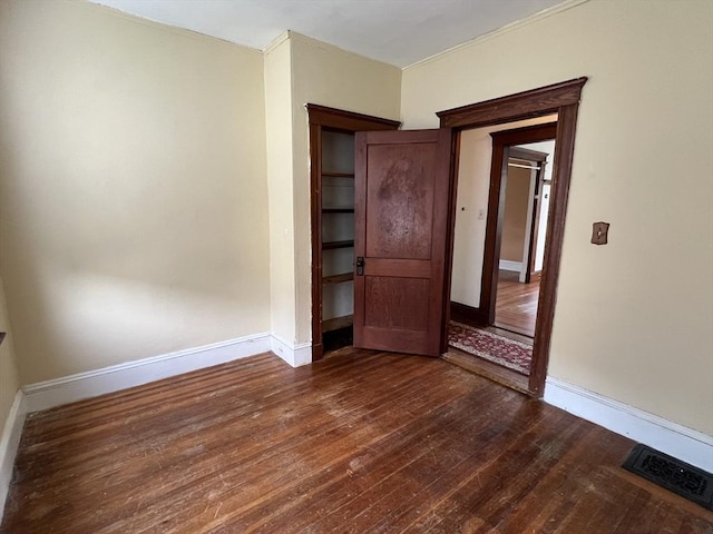 unfurnished bedroom with dark hardwood / wood-style floors