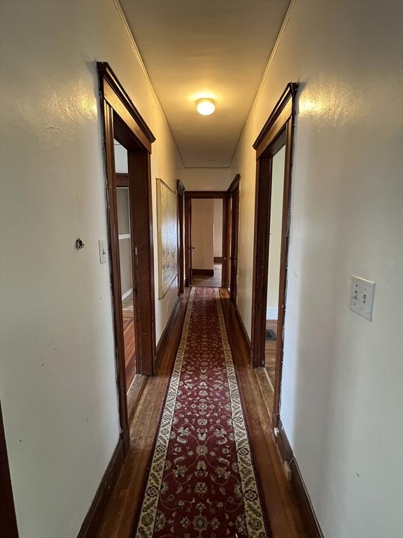 hall with dark hardwood / wood-style floors