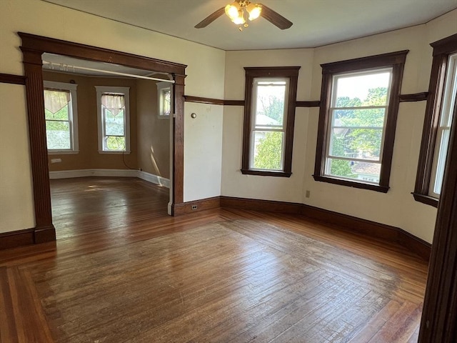 spare room with dark hardwood / wood-style floors and ceiling fan