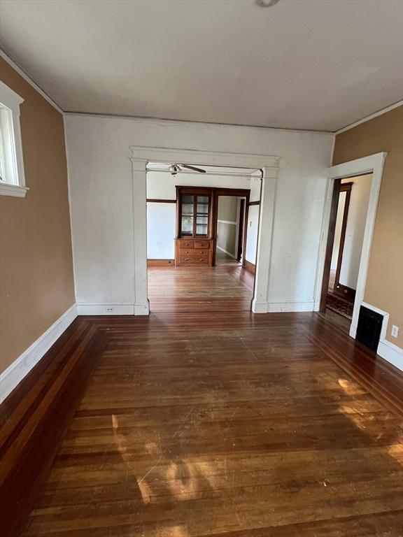 empty room featuring dark hardwood / wood-style floors and ceiling fan