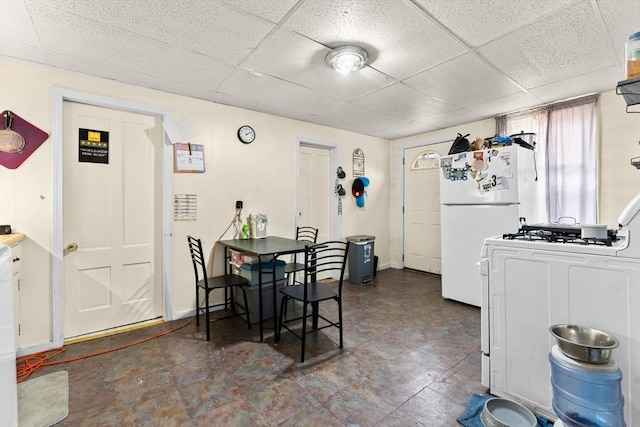 dining area featuring a drop ceiling